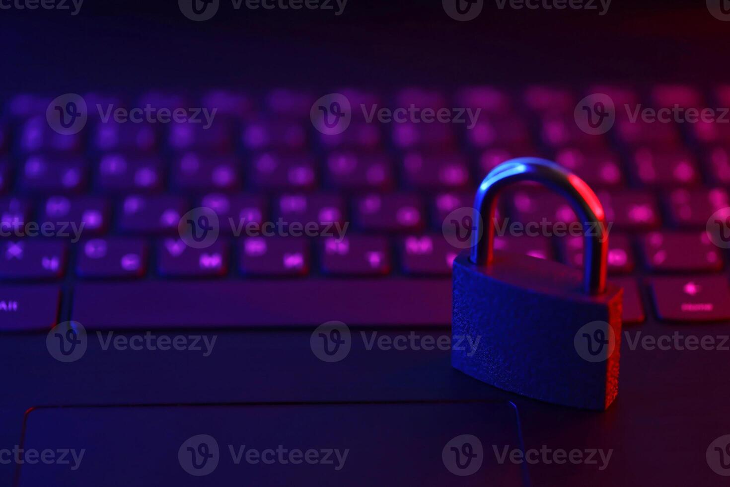 Computer security concept with a closed padlock on the keyboard. Padlock on top of a laptop keyboard. Selective focus photo