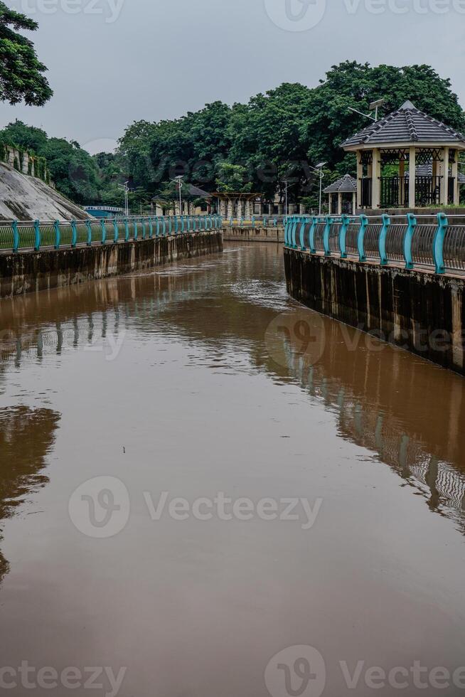river water flowing fast after the rain with dirty brown water. photo