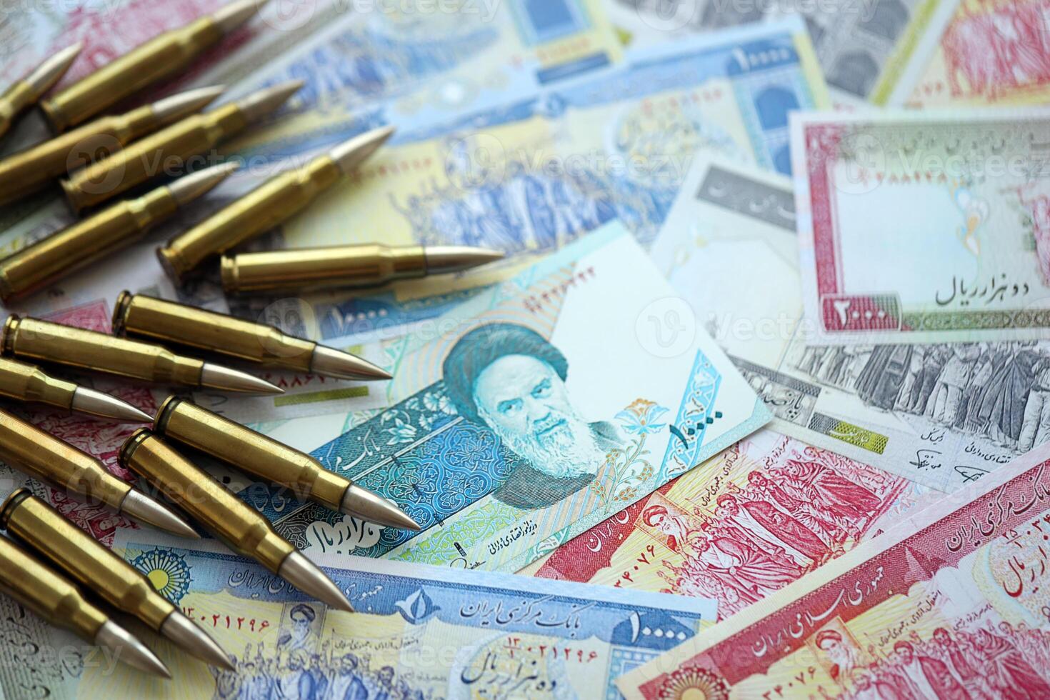 Many bullets and iranian rials money bills close up. Concept of terrorism funding or financial operations to support war photo