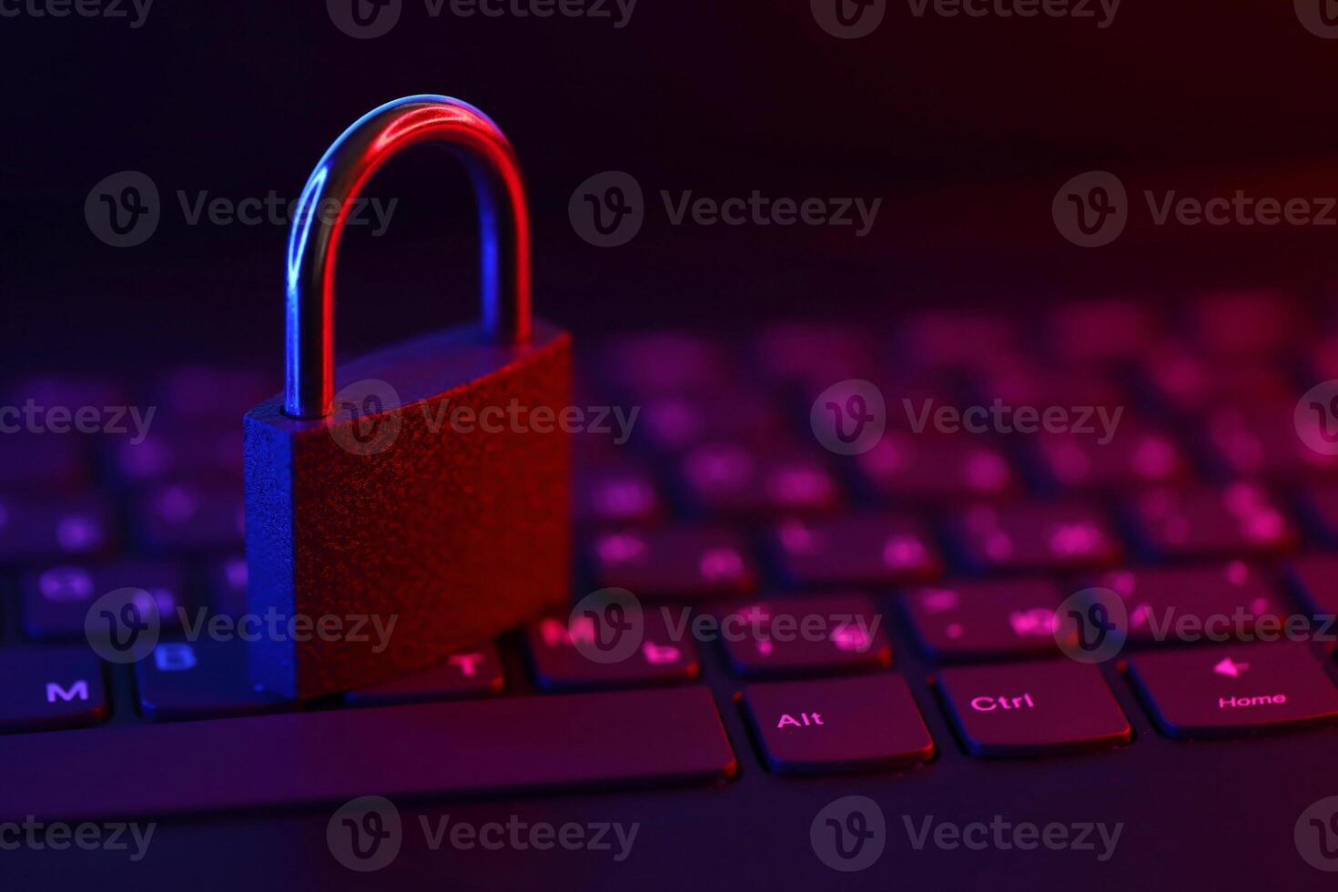 Computer security concept with a closed padlock on the keyboard. Padlock on top of a laptop keyboard. Selective focus photo