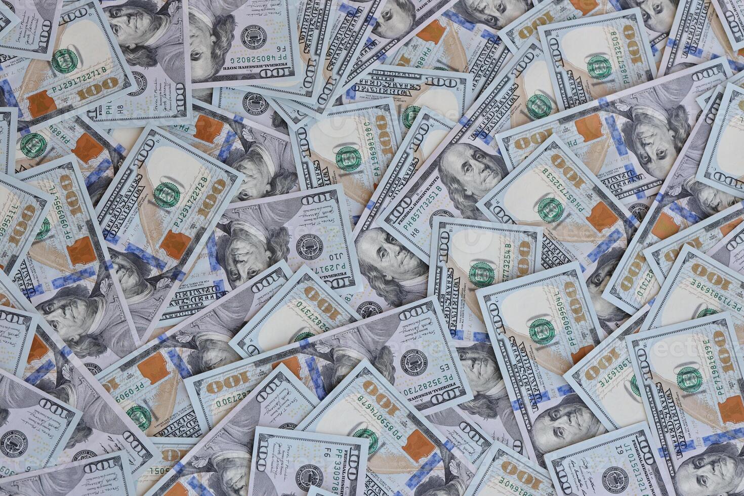 Very big amount of US hundred dollar bills. Huge quantity of united states currency notes on flat table photo