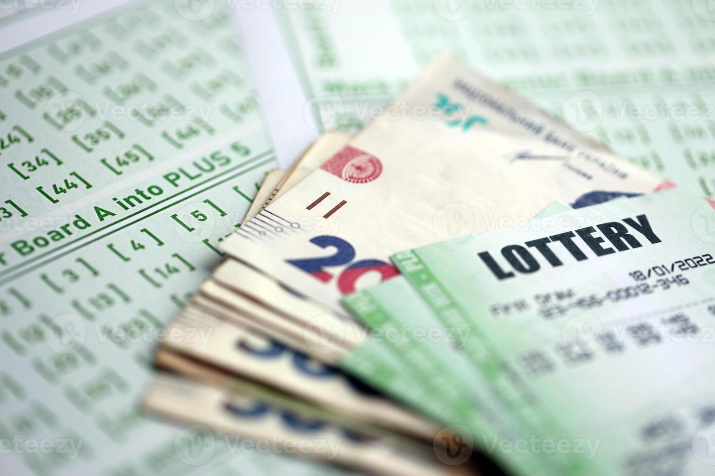 Green lottery tickets and ukrainian money bills on blank with numbers for playing lottery photo