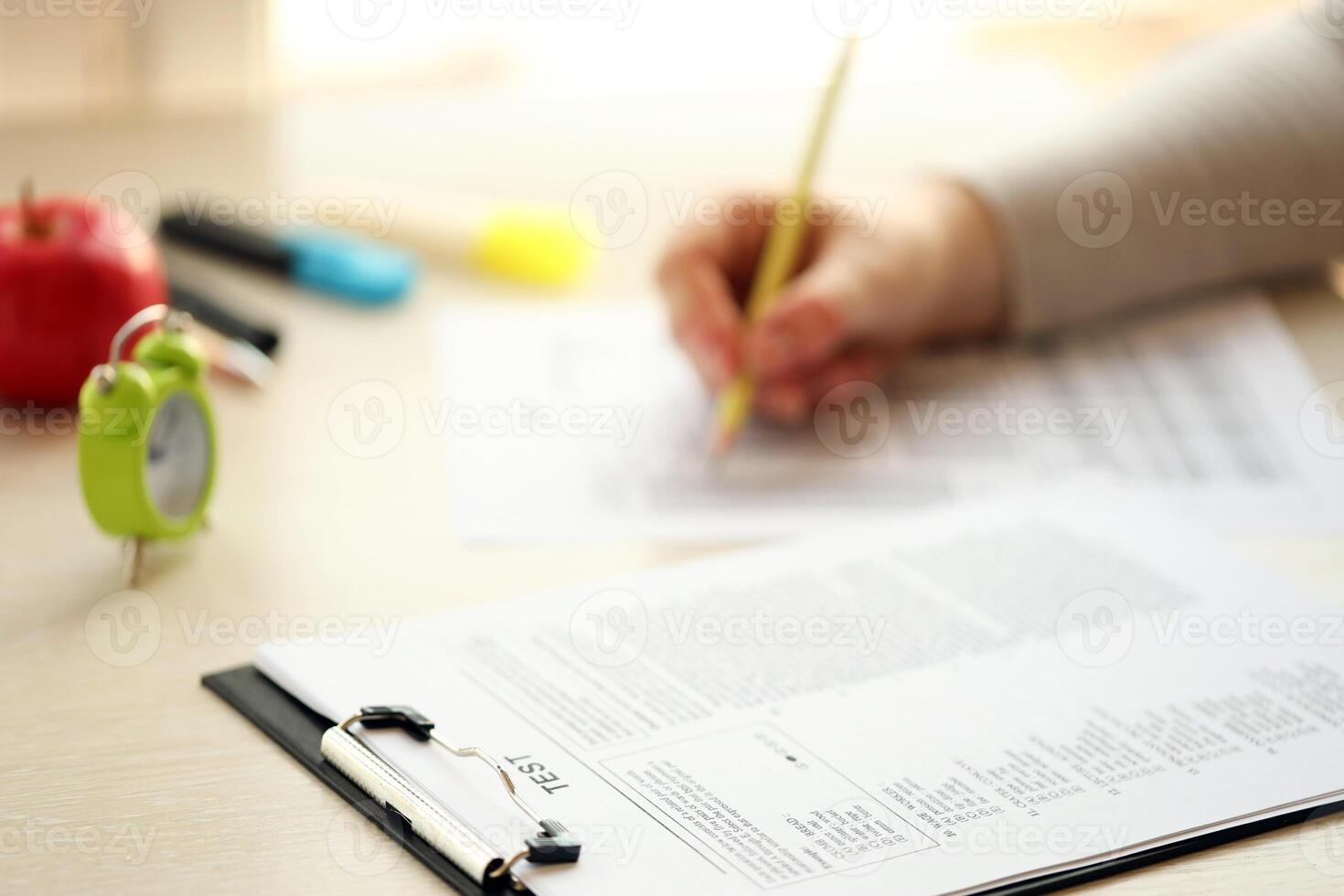 Female student hands testing in exercise and taking fill in exam paper sheet with pencil at school test photo