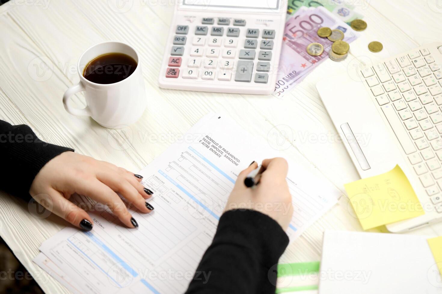 Accountant fill italian tax form F23 Payment model taxes duties penalties and other revenues in end of tax period. Taxation and paperwork routine photo