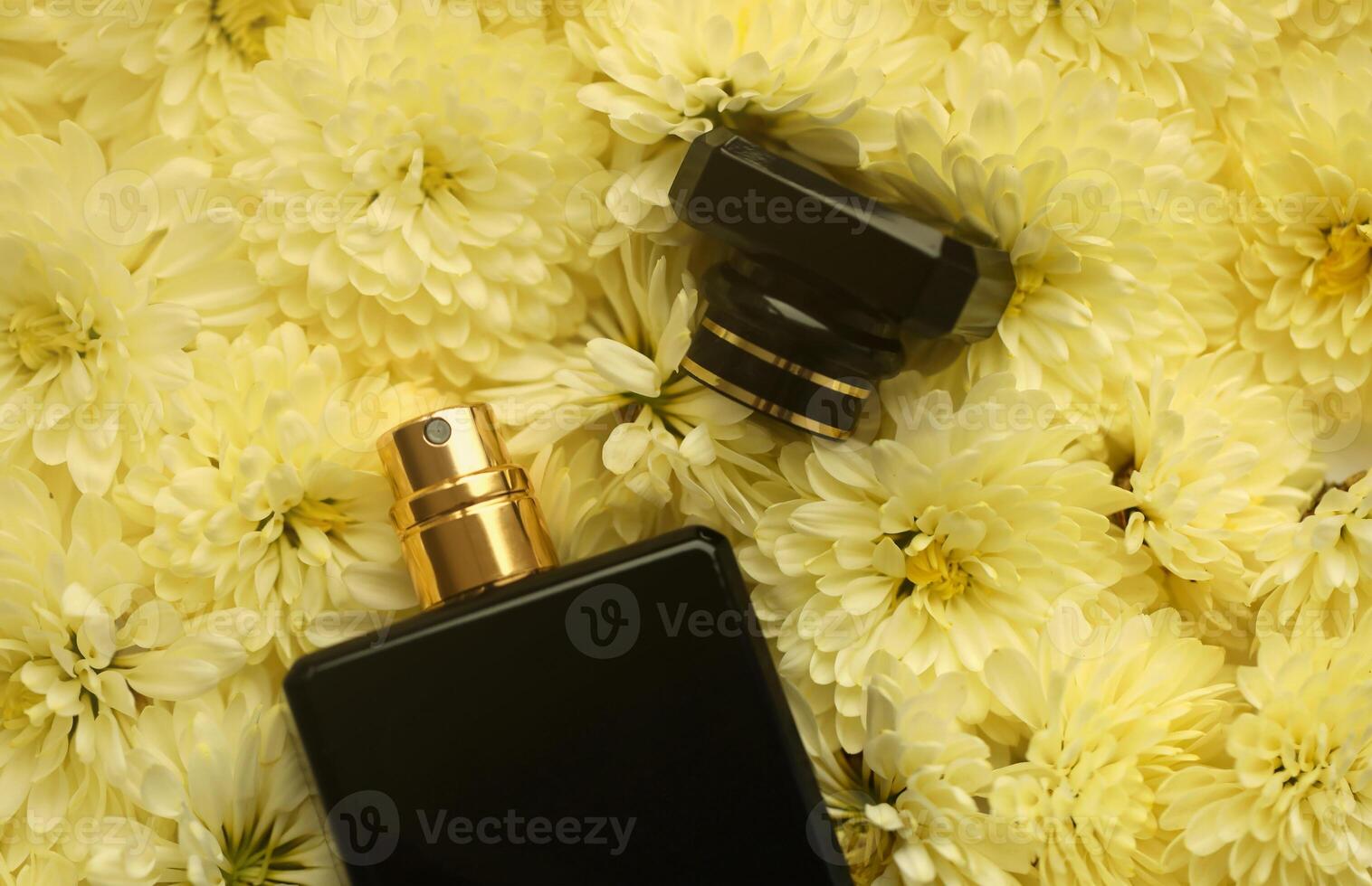 Women fragrance perfume bottle with flowers background close up. Unnamed blank sprayer bottle of perfume photo