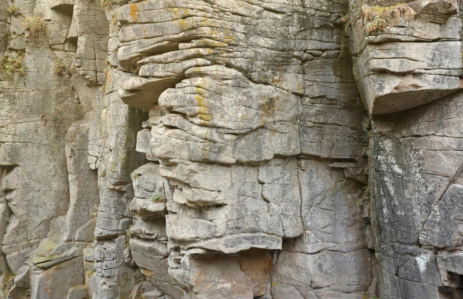 Light coarse natural rock stone background. Mining cliff rough front surface. Big limestone stack backdrop. Heavy grunge damaged granite block texture photo
