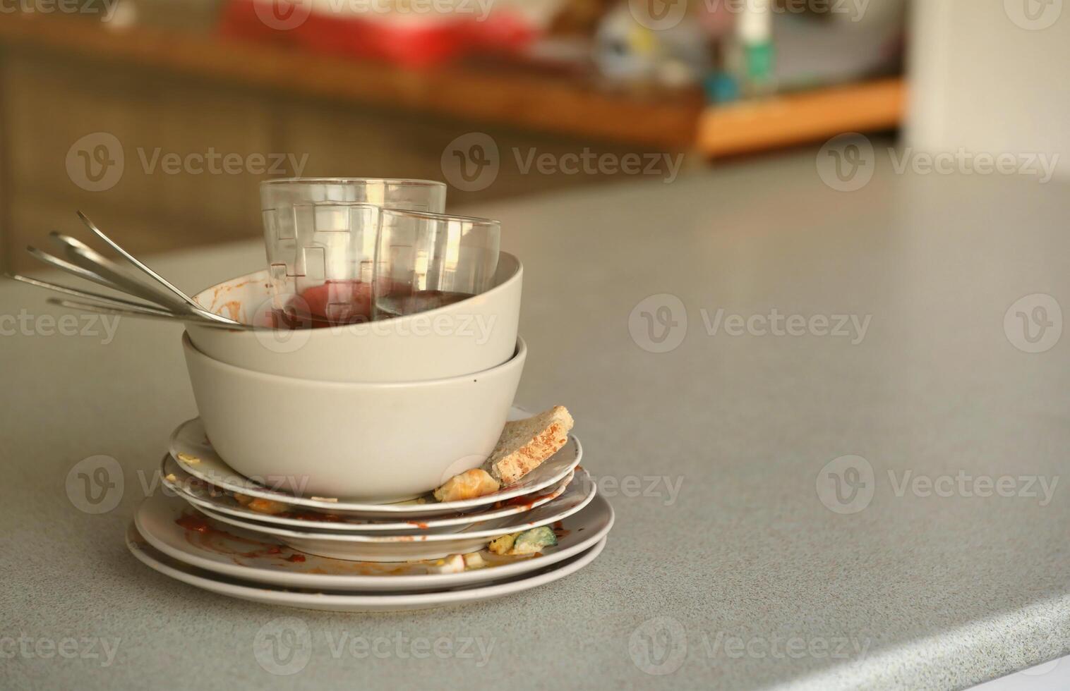 Stack of dirty dishes with food leftovers on the table after meal. Banquet ending concept. Unwashed dishes photo