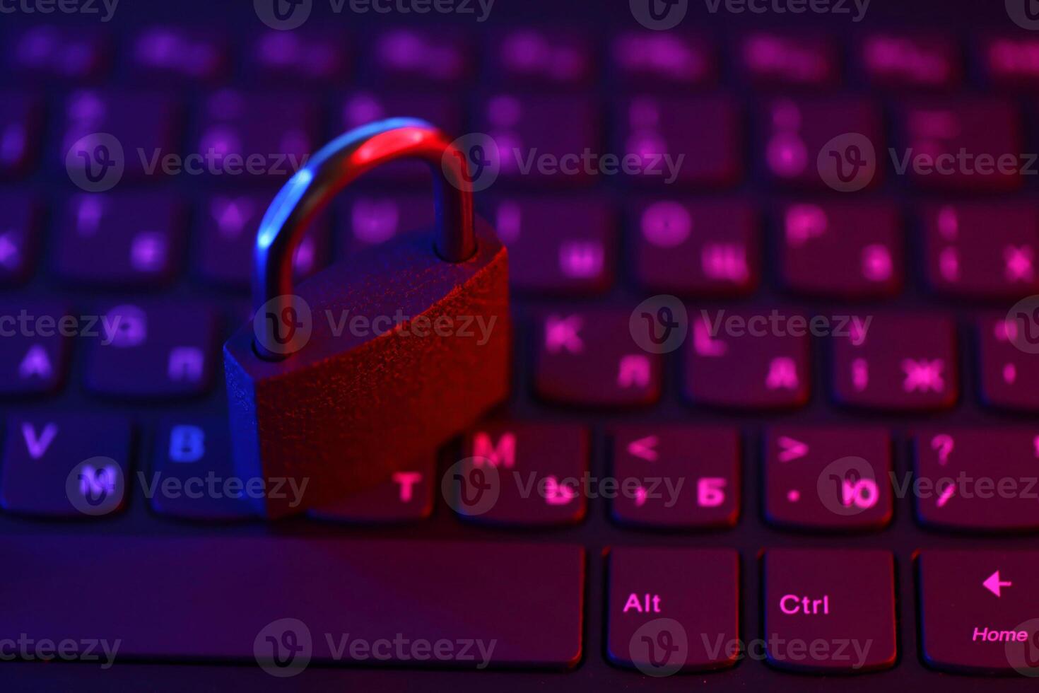 Computer security concept with a closed padlock on the keyboard. Padlock on top of a laptop keyboard. Selective focus photo
