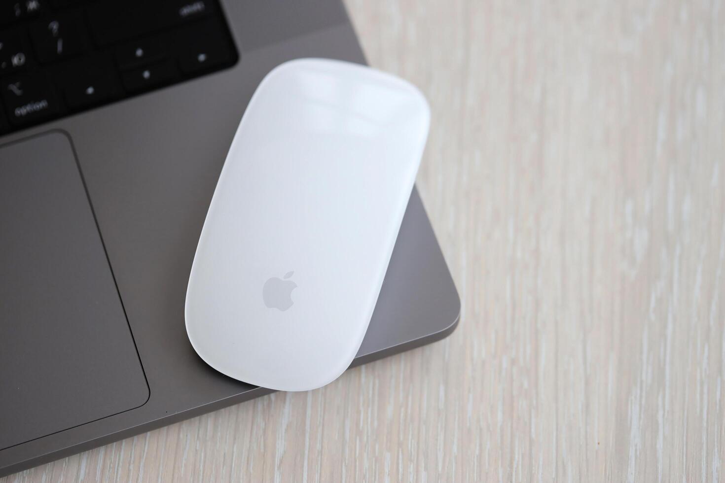 KYIV, UKRAINE - NOVEMBER 27, 2023 Apple Magic Mouse 3rd generation lies with grey MacBook 2021 photo