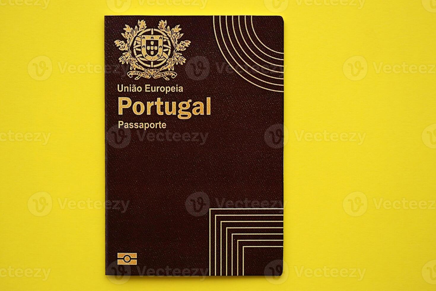 Red Portugal passport of European Union on yellow background close up photo