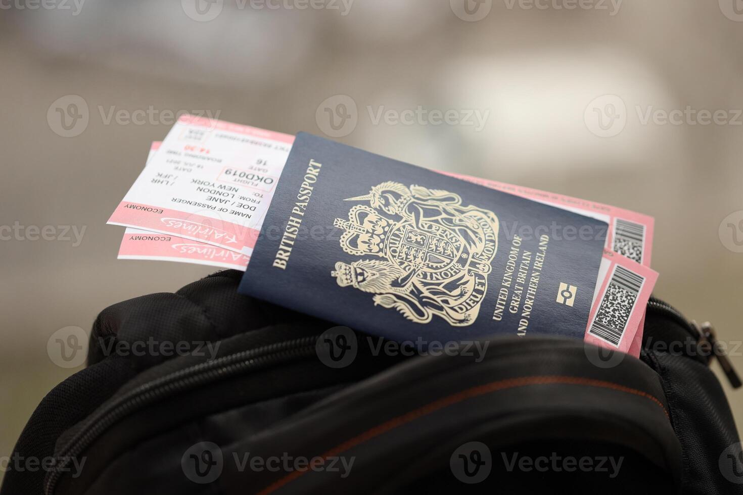 Blue British passport with airline tickets on touristic backpack photo