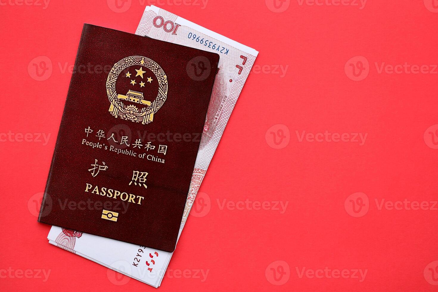 Red passport of People Republic of China and chinese yuan money bills. PRC chinese passport photo