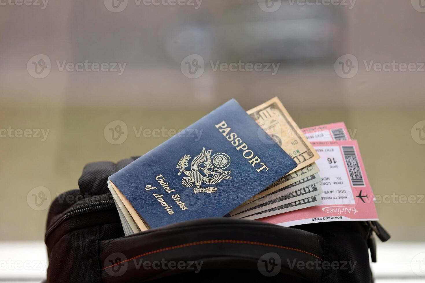 Blue United States of America passport with money and airline tickets on touristic backpack photo