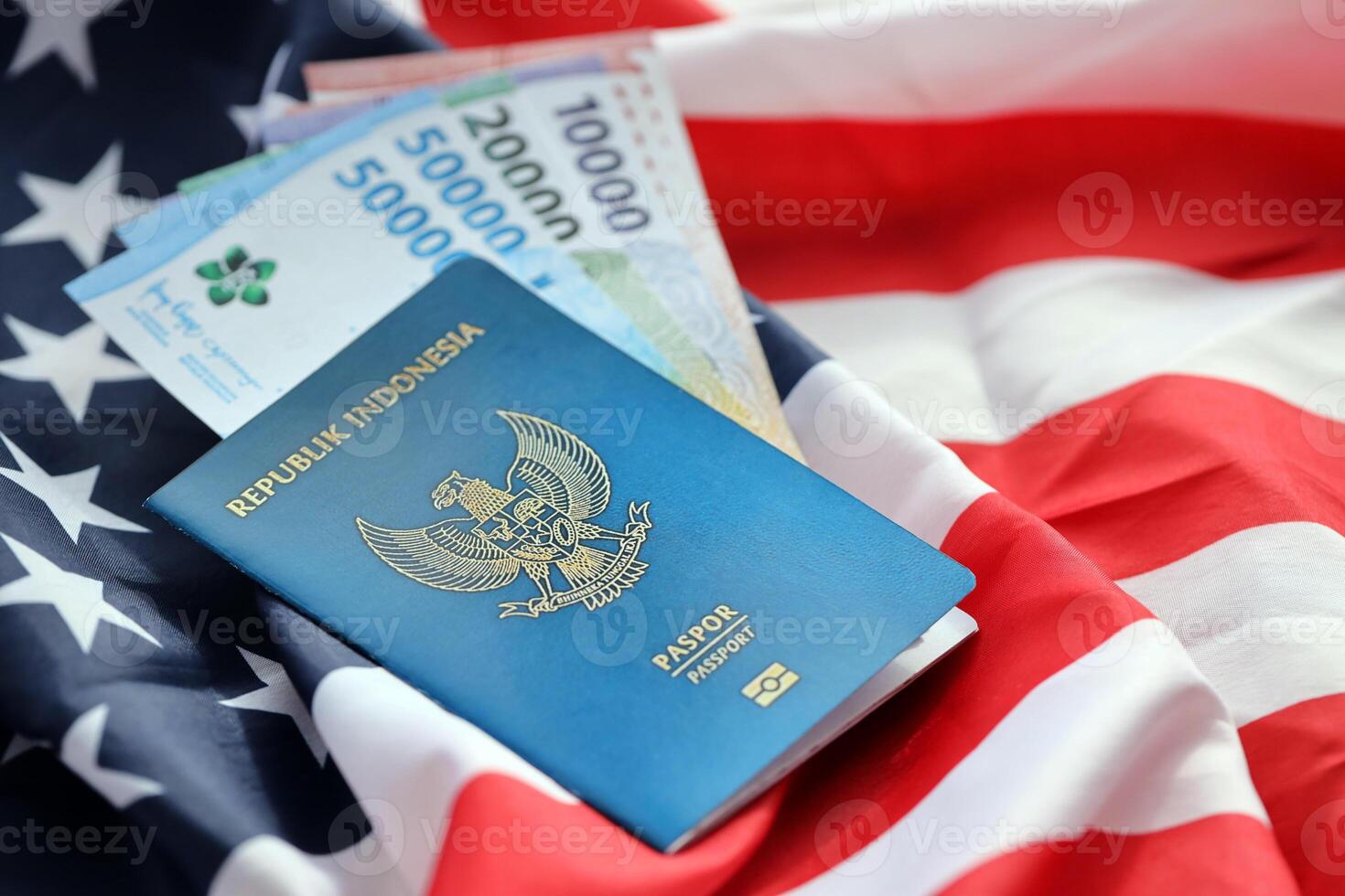 Blue Republic Indonesia passport and money on United States national flag background photo