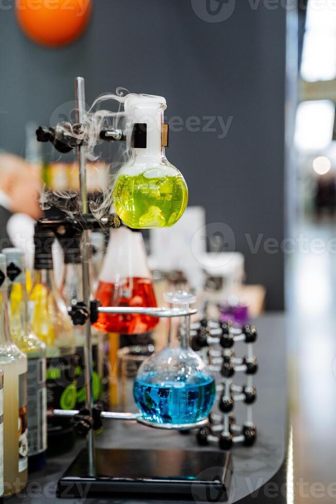 Chemical laboratory for the study of pathogenic viruses, glass flasks are fixed on a tripod, a bar of alcoholic beverages in a restaurant. photo