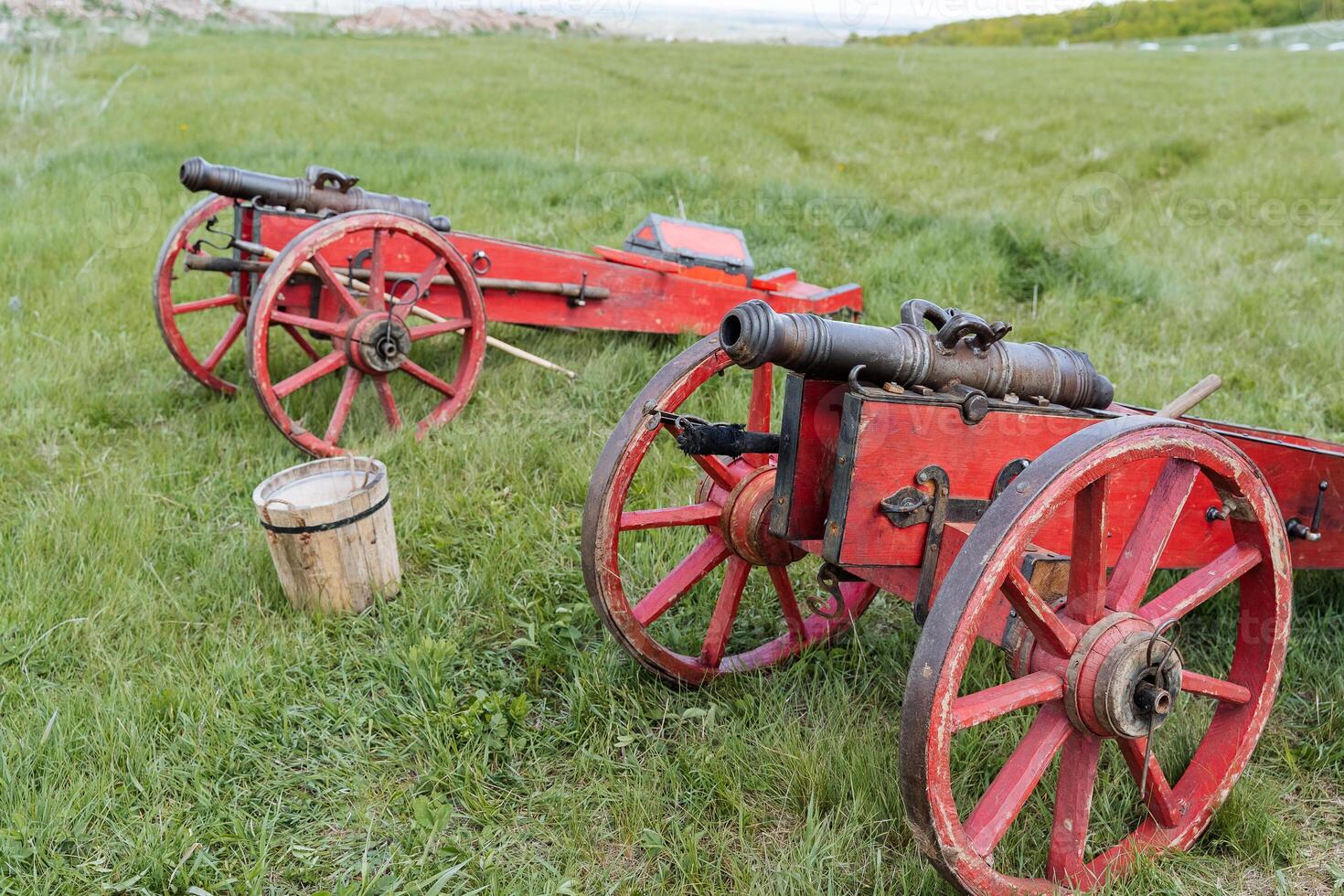 Ancient cannons on wheels, tools of the Middle Ages, cast iron cannons of the time of Peter the Great, reconstruction of historical weapons firing cannonballs. photo