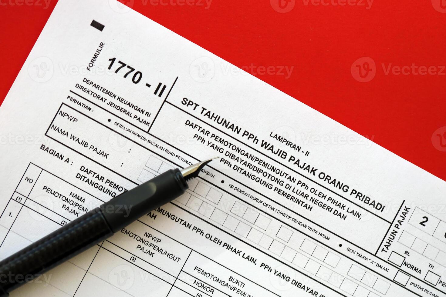 Indonesian tax form 1770-2 Individual Income Tax Return and pen on table photo
