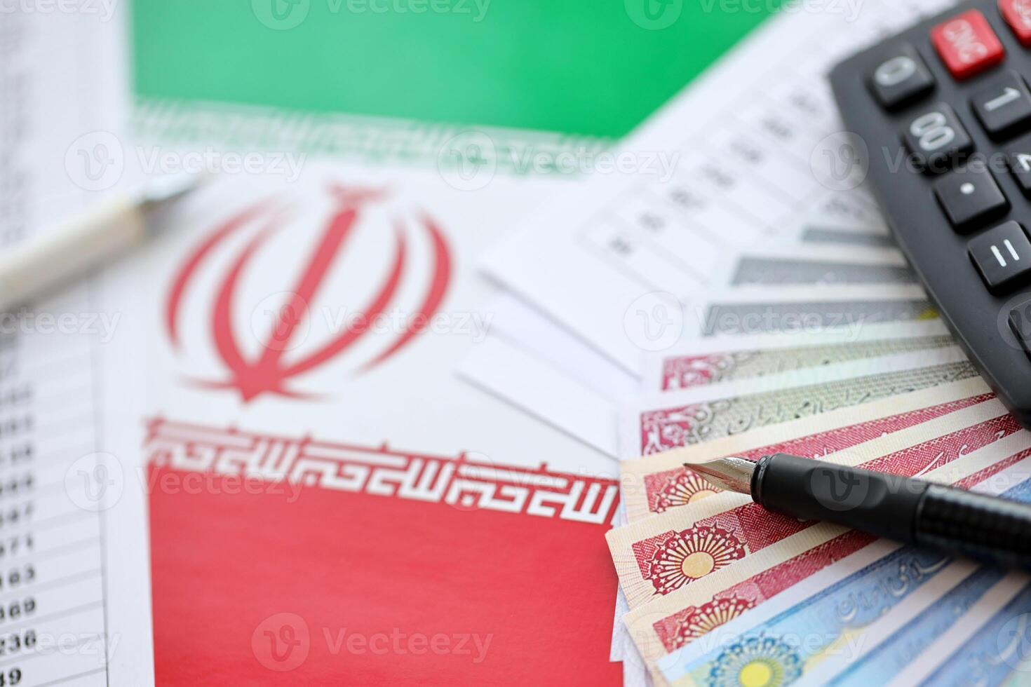 Iranian business calculations on table with iranian money and pen photo