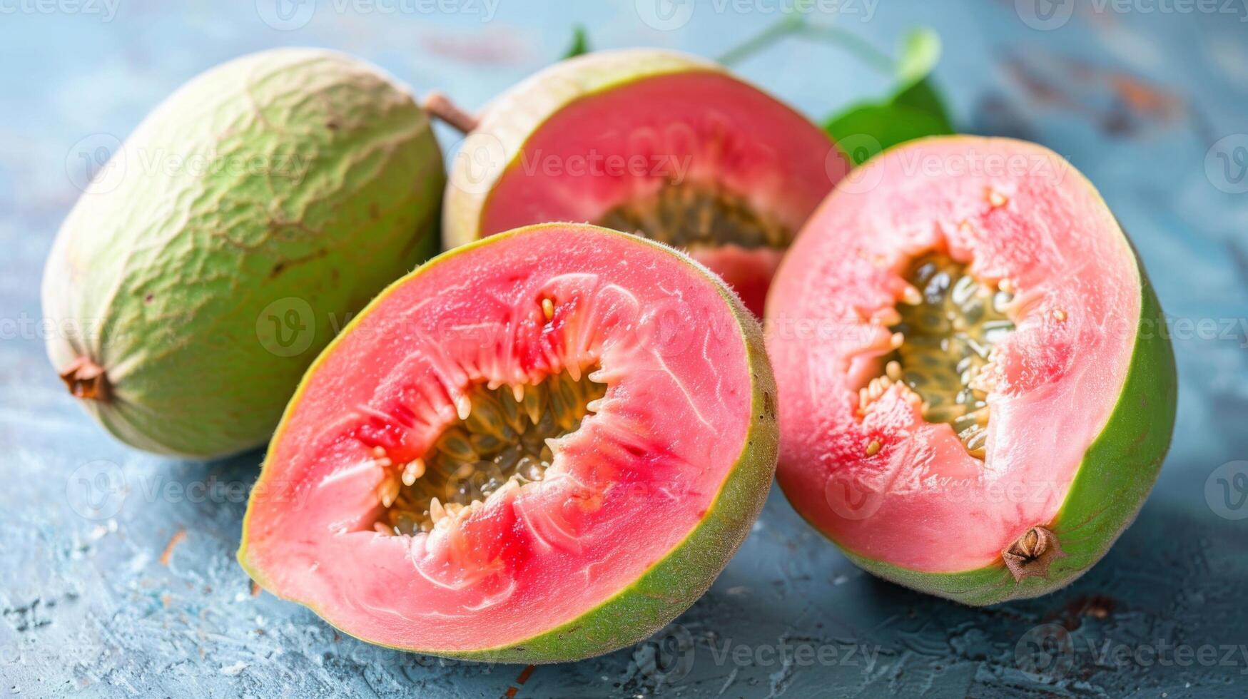 Fresh guava fruit with succulent pink flesh and seeds displayed on a textured background photo