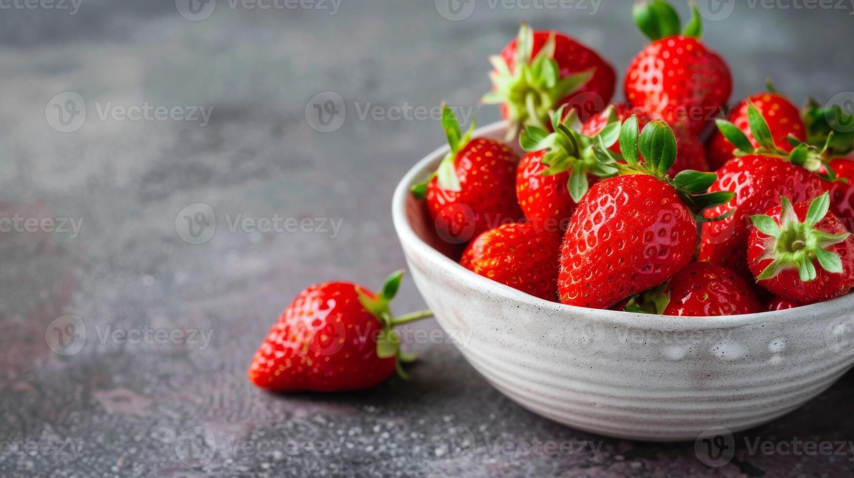 Fresh strawberries in a ceramic bowl with ripe red berries and a sweet juicy texture photo