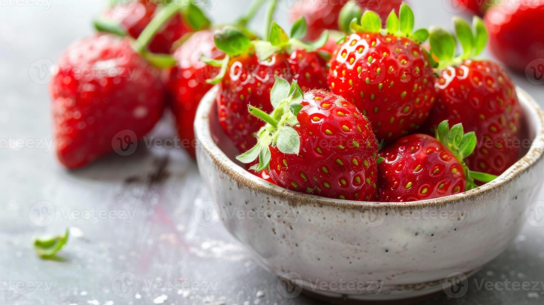 Fresh strawberries in a ceramic bowl, ripe and juicy fruit with a vibrant red color photo