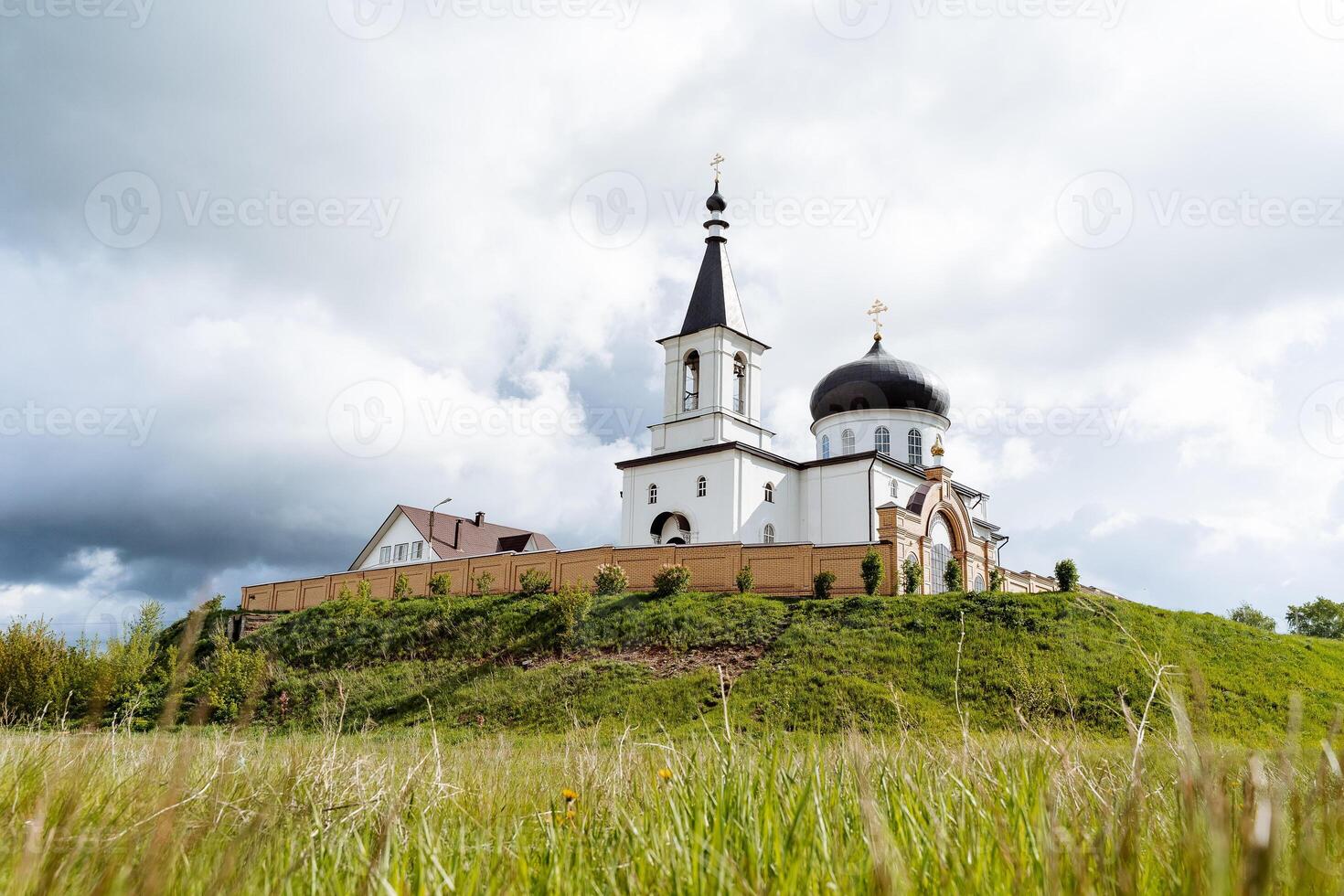 Orthodox monastery for believers, Church in Russia city of Birsk Bashkortostan. The temple against the background of the sky, the fortress structure is a high moat. photo