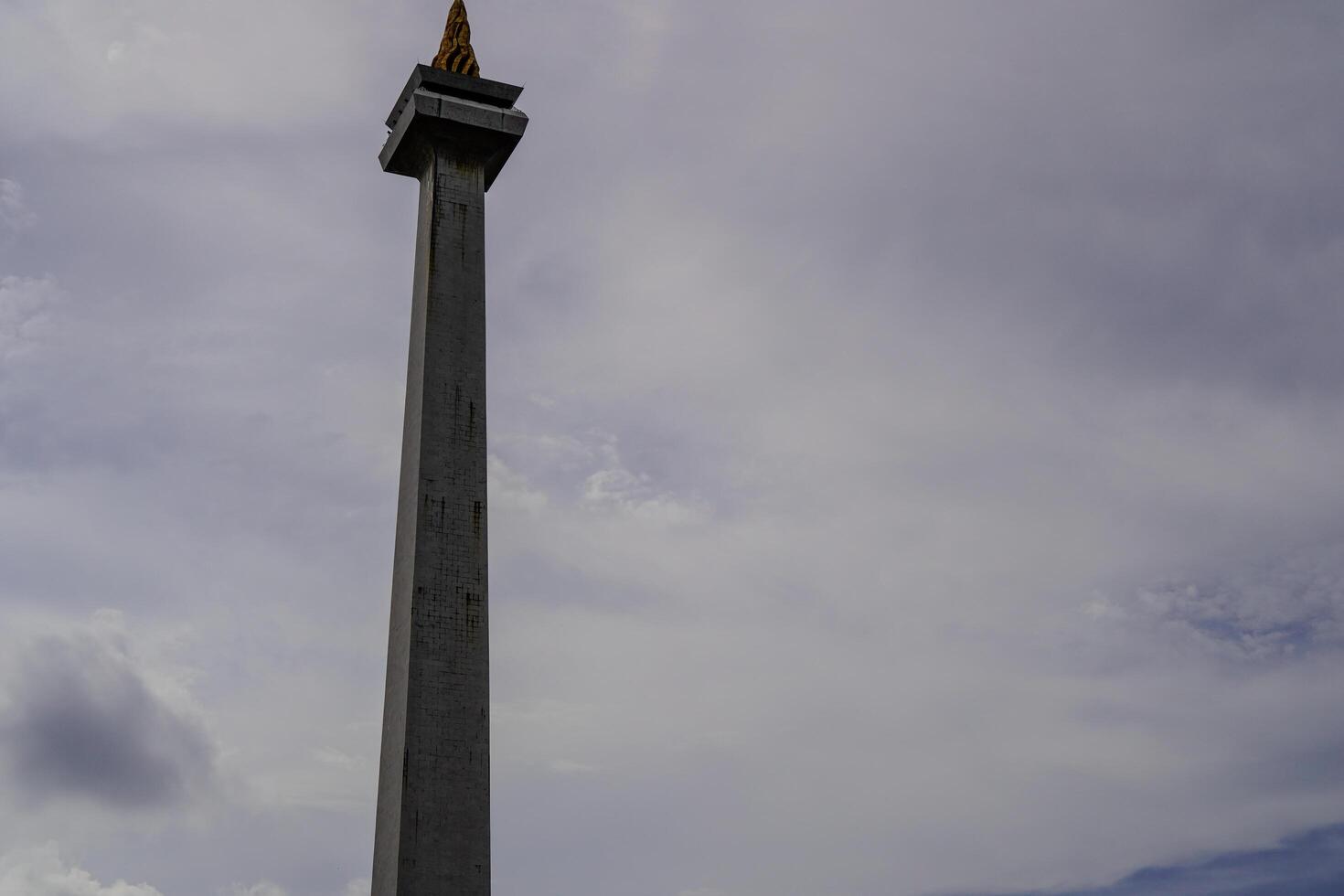 Central Jakarta, January 30, 2024 - National monument with a beautiful background of clouds in the sky during the day. photo