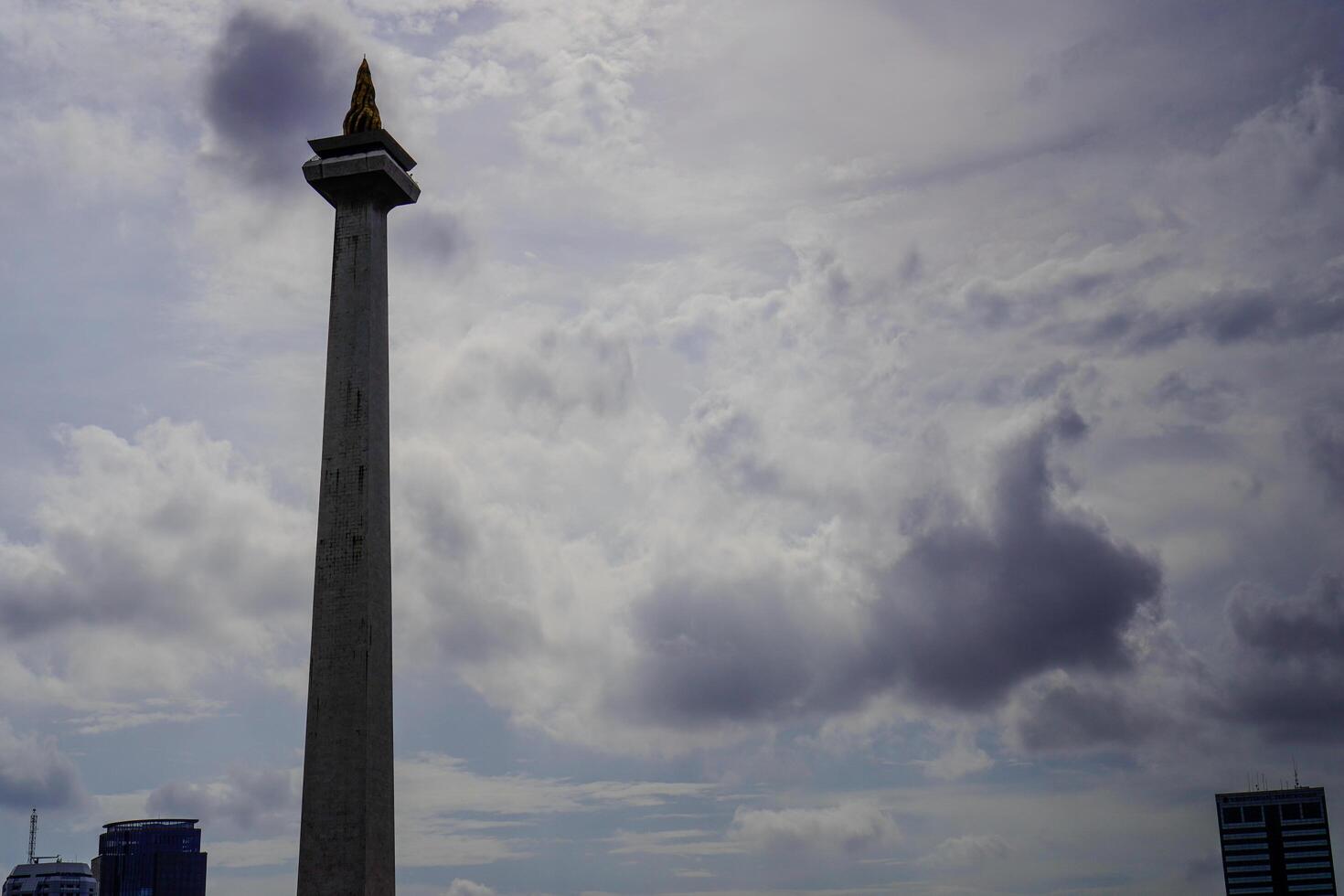 Central Jakarta, January 30, 2024 - National monument with a beautiful background of clouds in the sky during the day. photo