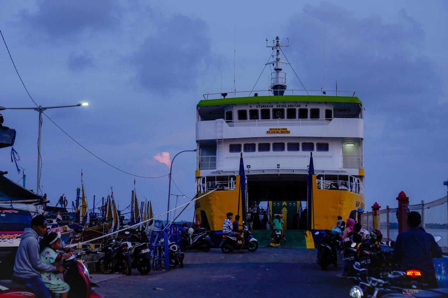 Jepara Central Java, April 7, 2024 - rear view of an inter-island crossing ship against the background of the evening sky with free space for photocopying. front view of the ship docked at the Jepara photo