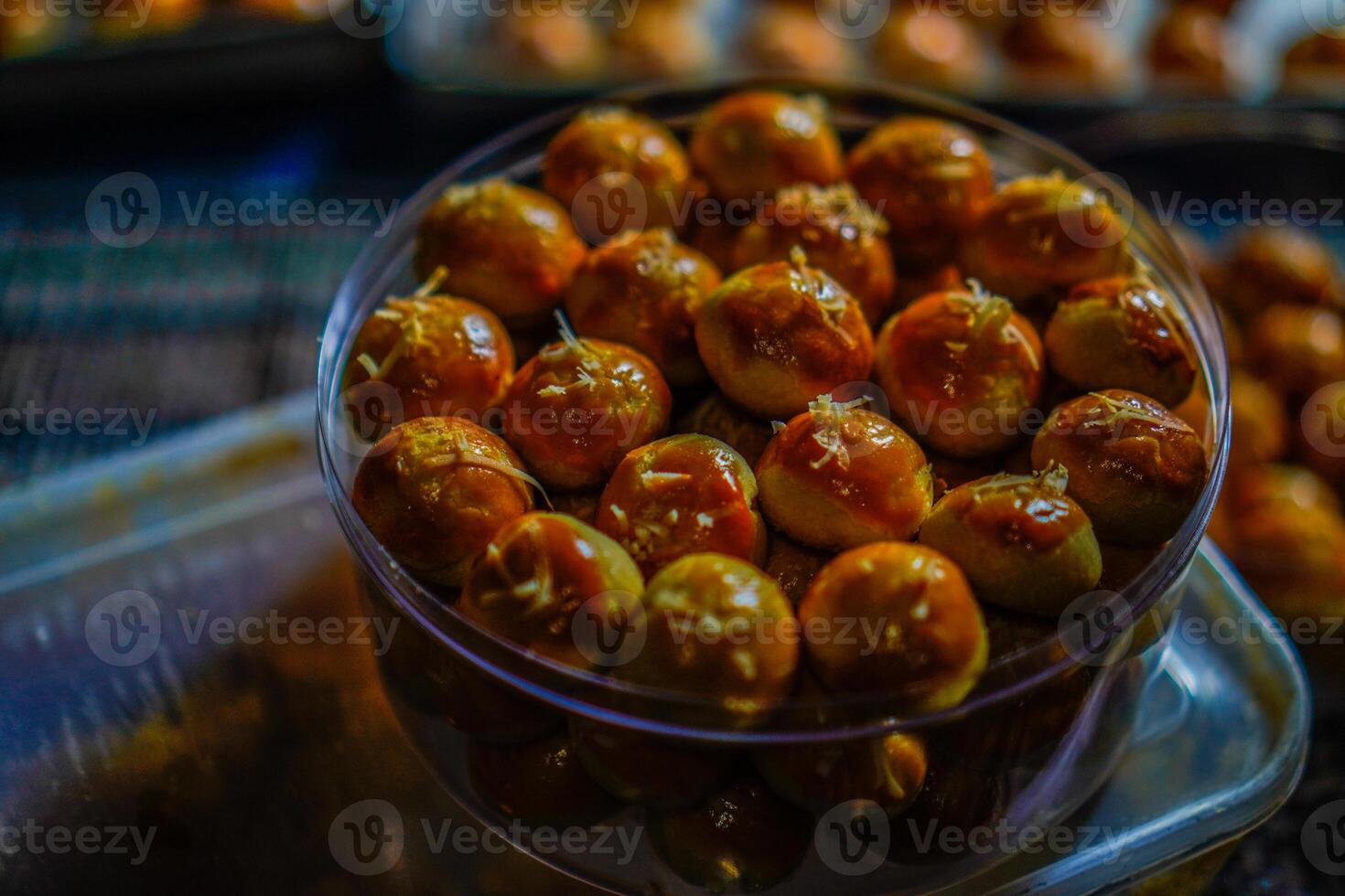 Close-up view of pineapple cake in a transparent jar on the table. photo