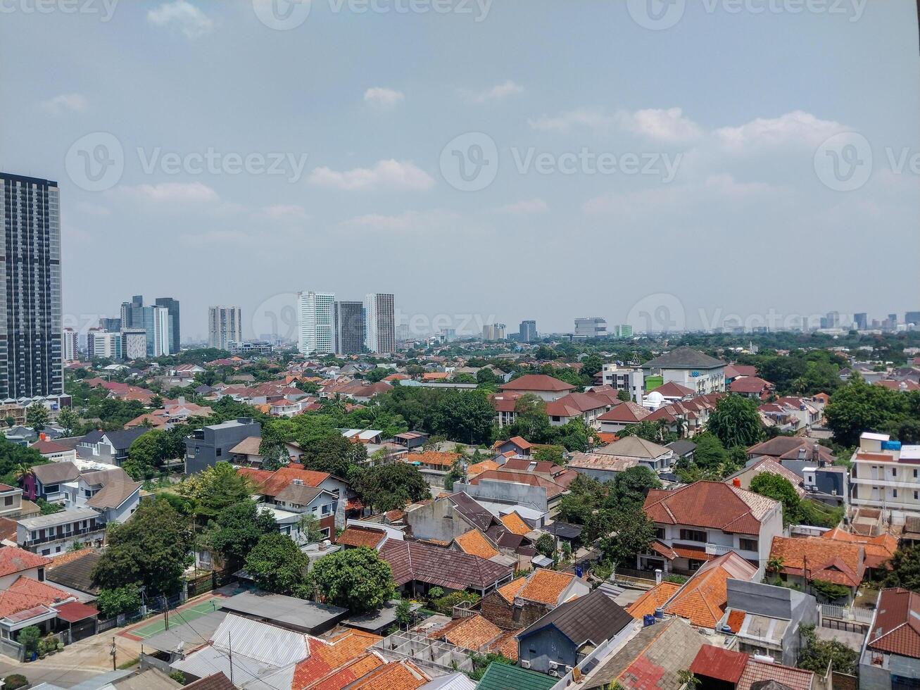 top view of people's houses with skyscrapers looking far away. photo