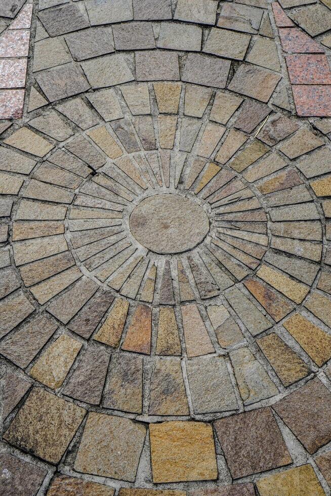 top view of the floor with natural stone neatly arranged with circular dots at the posts photo