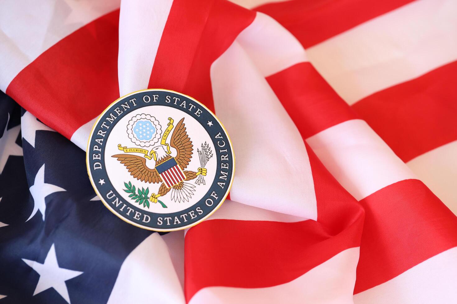 KYIV, UKRAINE - MARCH 9, 2024 US Department of State seal on United States of America flag photo