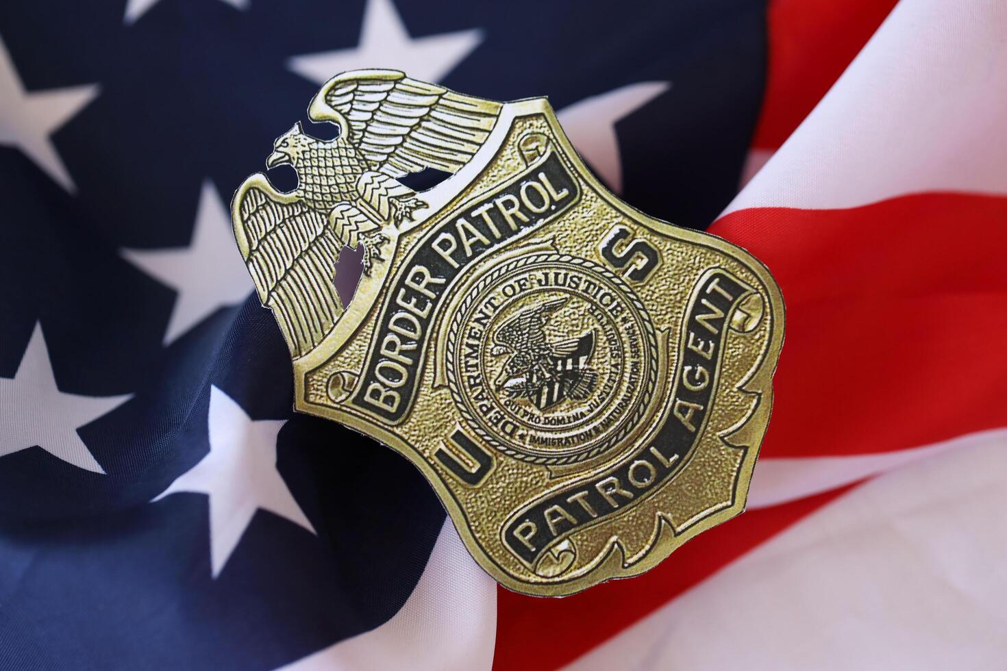 KYIV, UKRAINE - MARCH 9, 2024 US Border Patrol Agent badge on United States of America flag photo