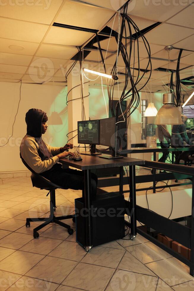 Encryption specialist using computer malware and virus to hack government network late at night, planning data breach to steal passwords. Hacker accessing important server and breaking system. photo