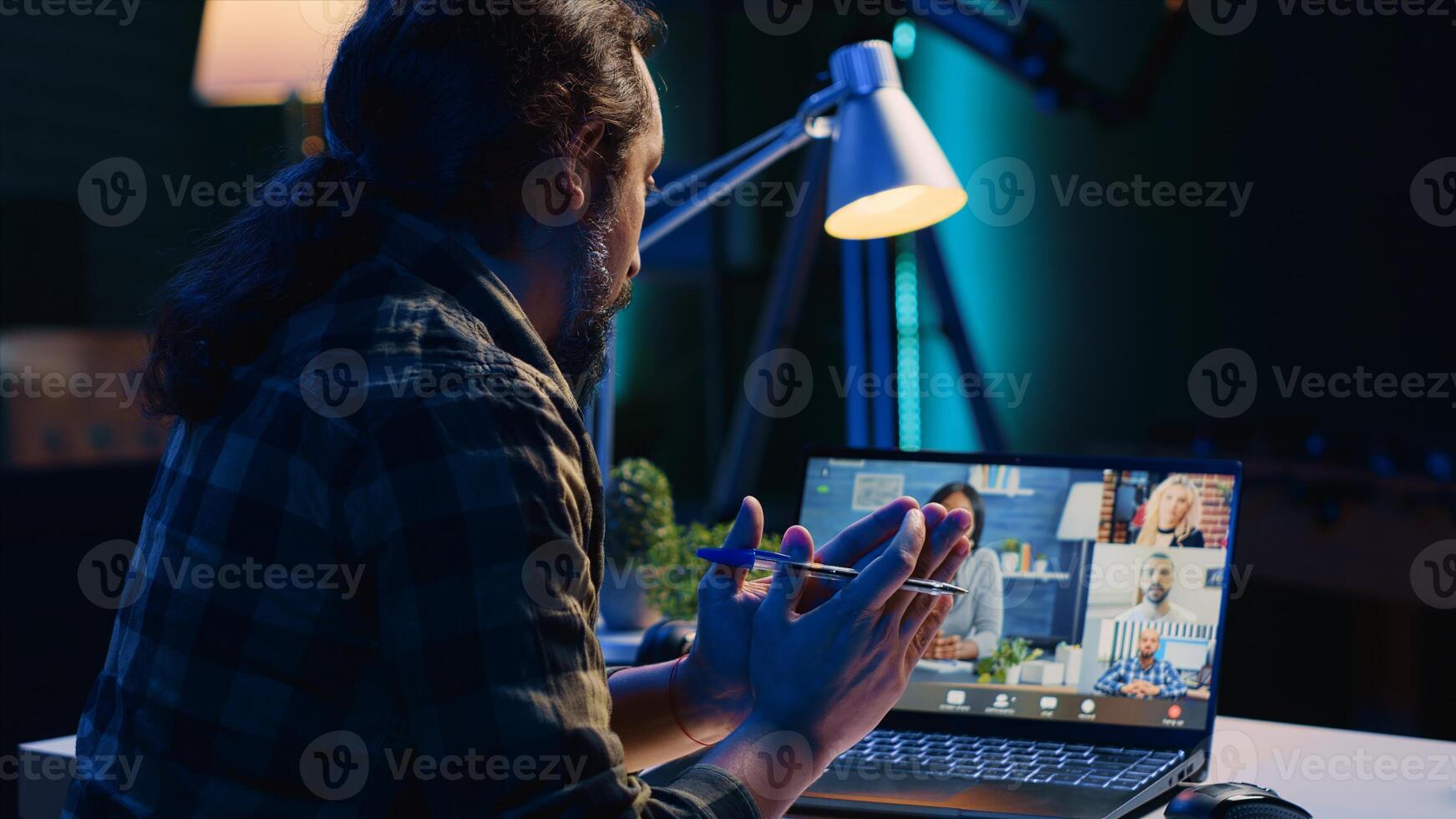 Remote worker talks with board of directors during videocall business meeting from home office. Teleworker speaks in remote videoconference telework call, receiving feedback from management, camera A photo