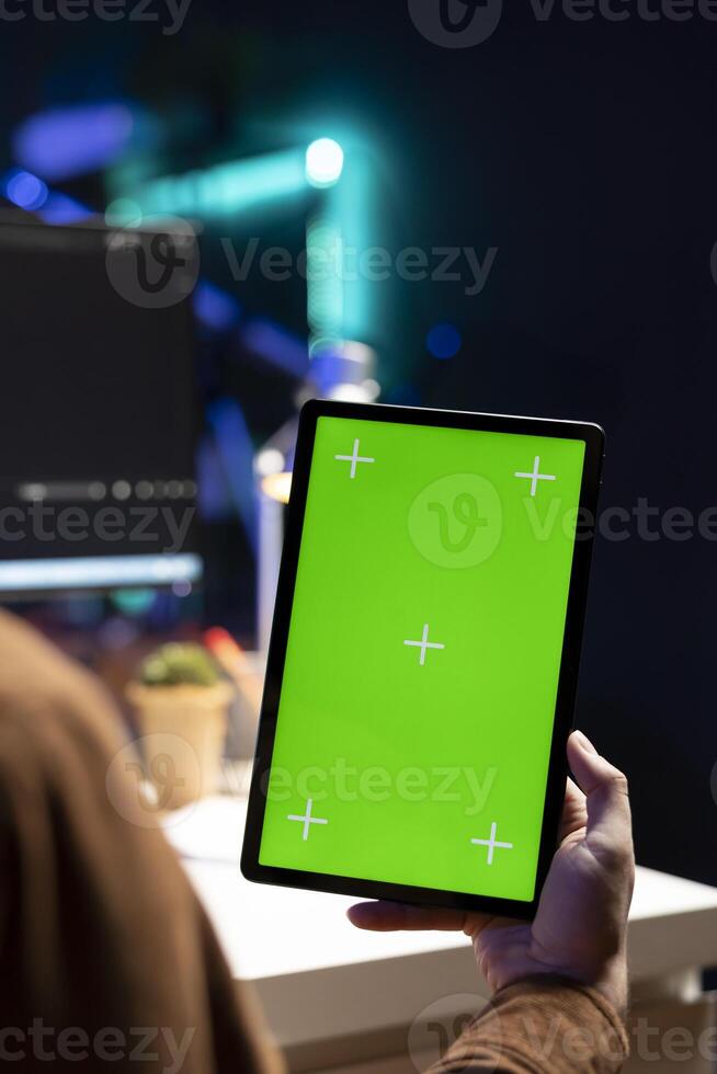 Cybersecurity expert using green screen tablet to secure company servers from virus attacks. IT remote employee writing code, building firewalls protecting data using mockup portable digital device photo
