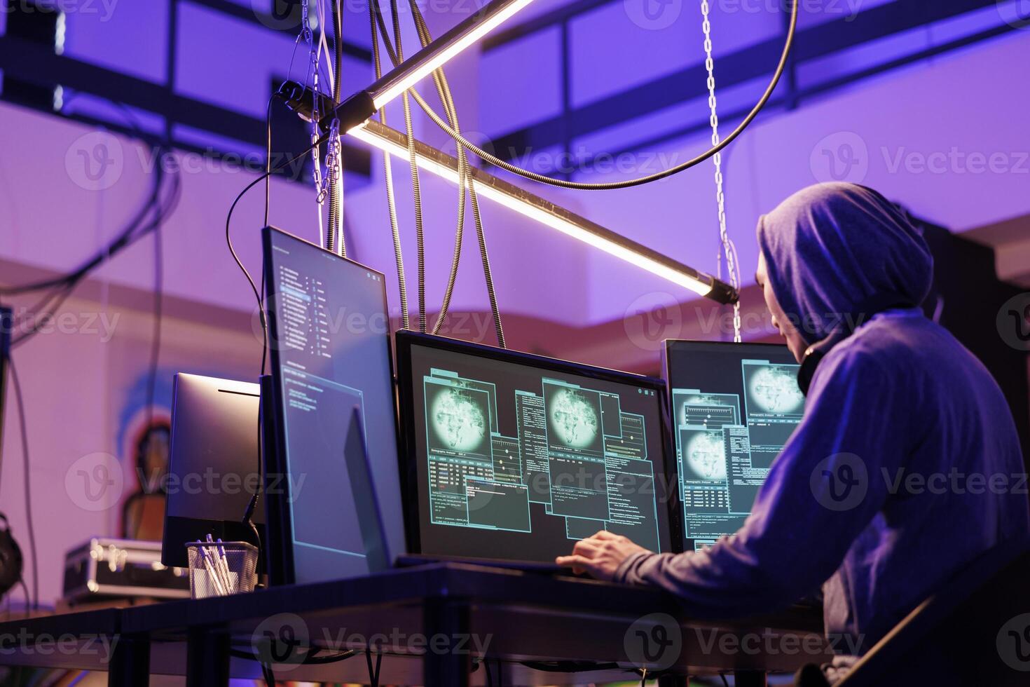 Hacker doing ddos attack on website and using password cracking malicious software on computer. Online scammer hood planning phishing cyberattack and internet fraud, breaking law photo