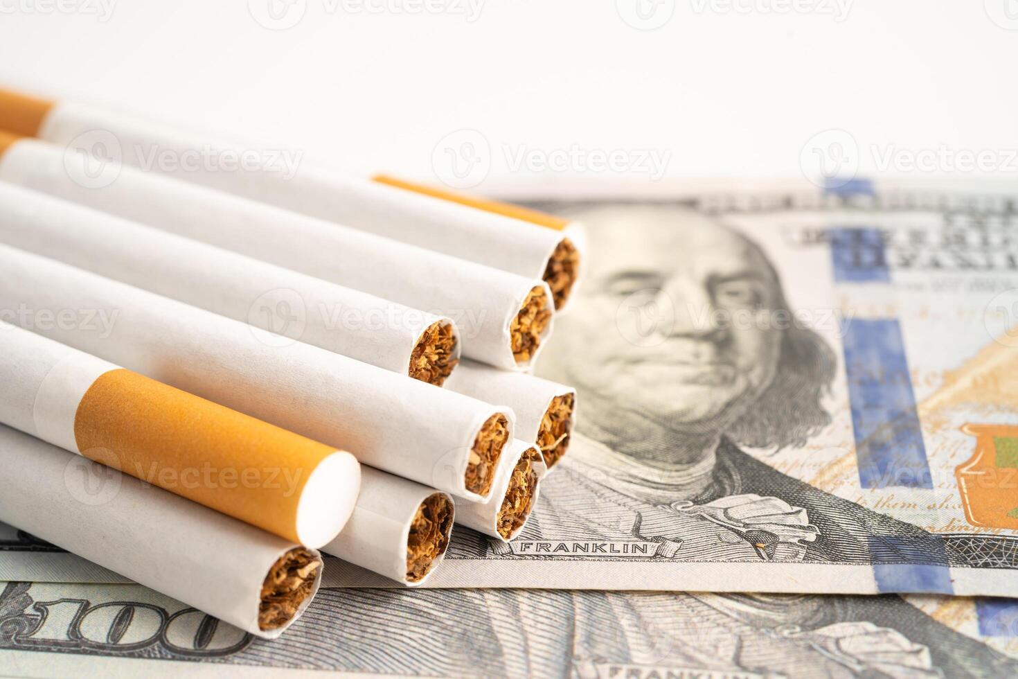 Cigarette on US dollar banknotes, cost, trading, marketing and production, No smoking. photo
