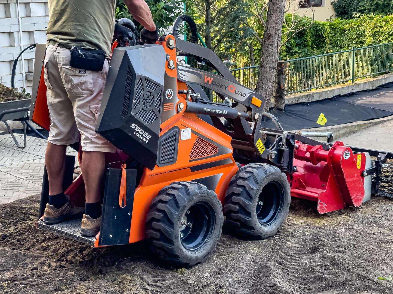 Nitra, Slovakia - 08.15.2023 Operation of a mechanical seeder. Planting a lawn. photo