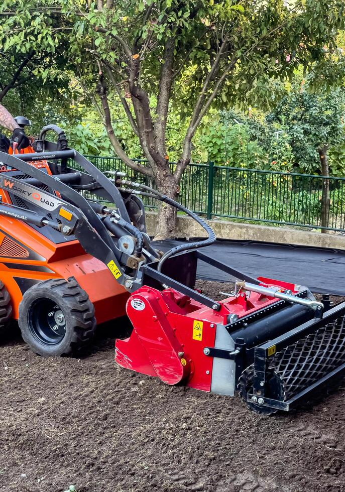 Nitra, Slovakia - 08.15.2023 Operation of a mechanical seeder. Planting a lawn. photo