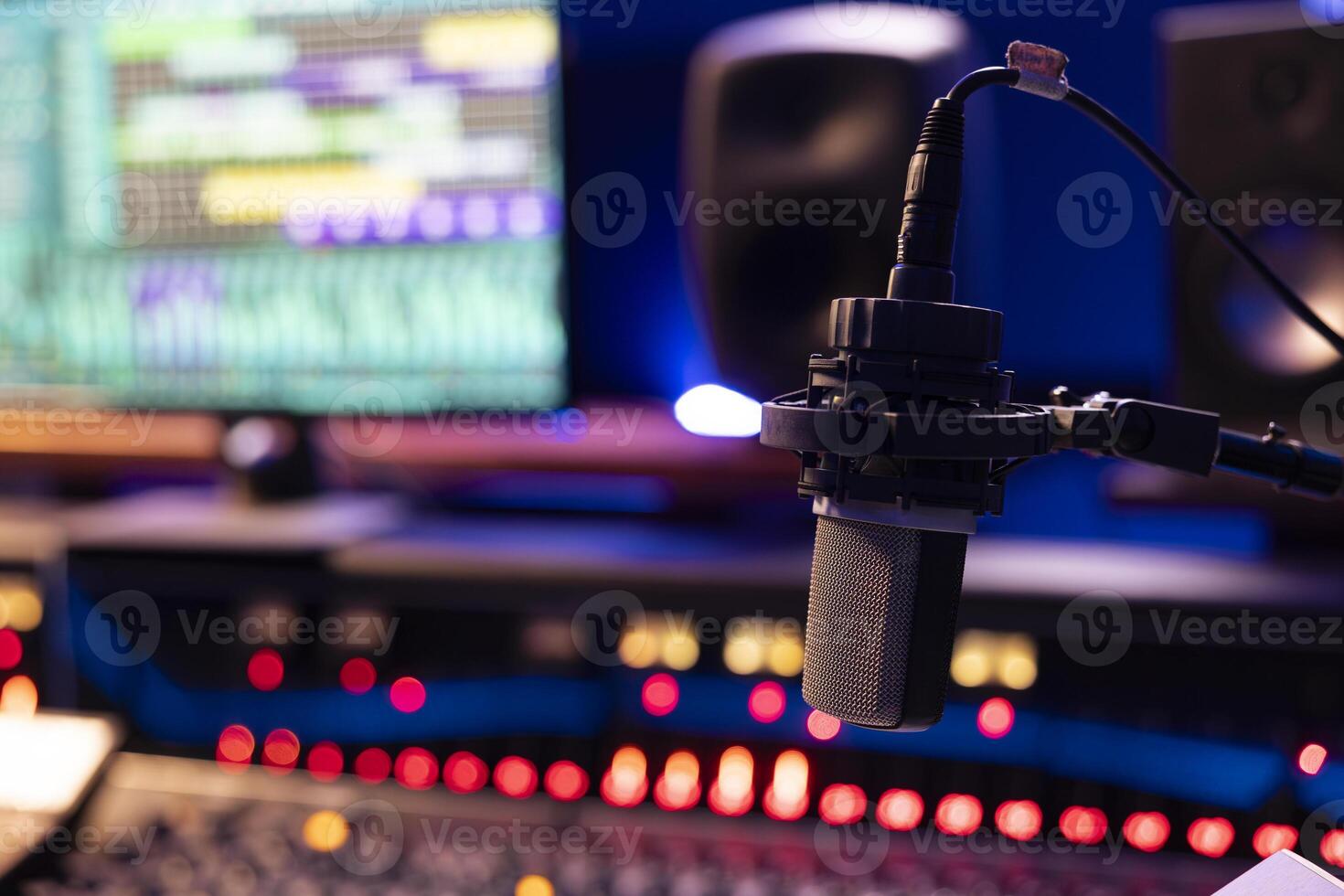 Empty control room with professional recording microphone and technical gear used for producing and editing music, sliders and buttons on panel board. Post production space. Close up. photo