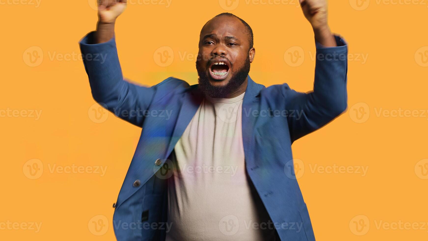 Approving joyful african american man happily clapping hands, ecstatic about accomplishments. Excited BIPOC person cheering, applauding, isolated over studio background, camera A photo