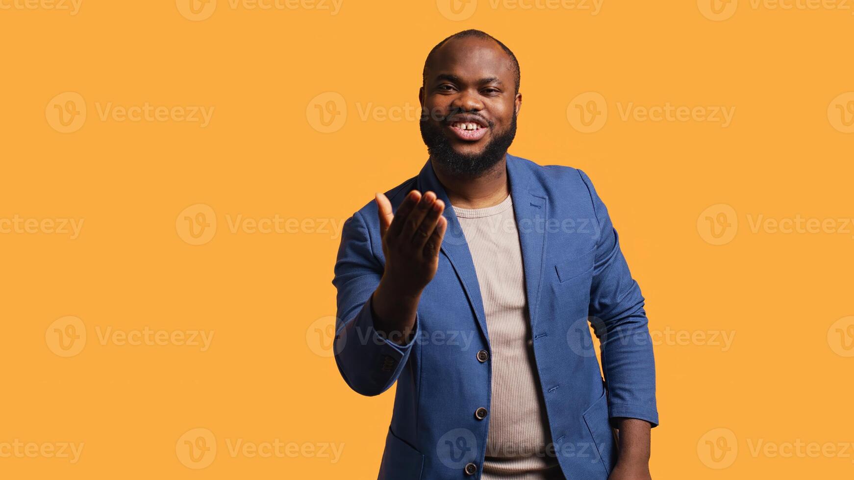 Frisky playful african american man blowing kisses to camera, being flirty. Lively charming BIPOC person having fun sending air kisses, doing romantic gesturing, studio background, camera B photo