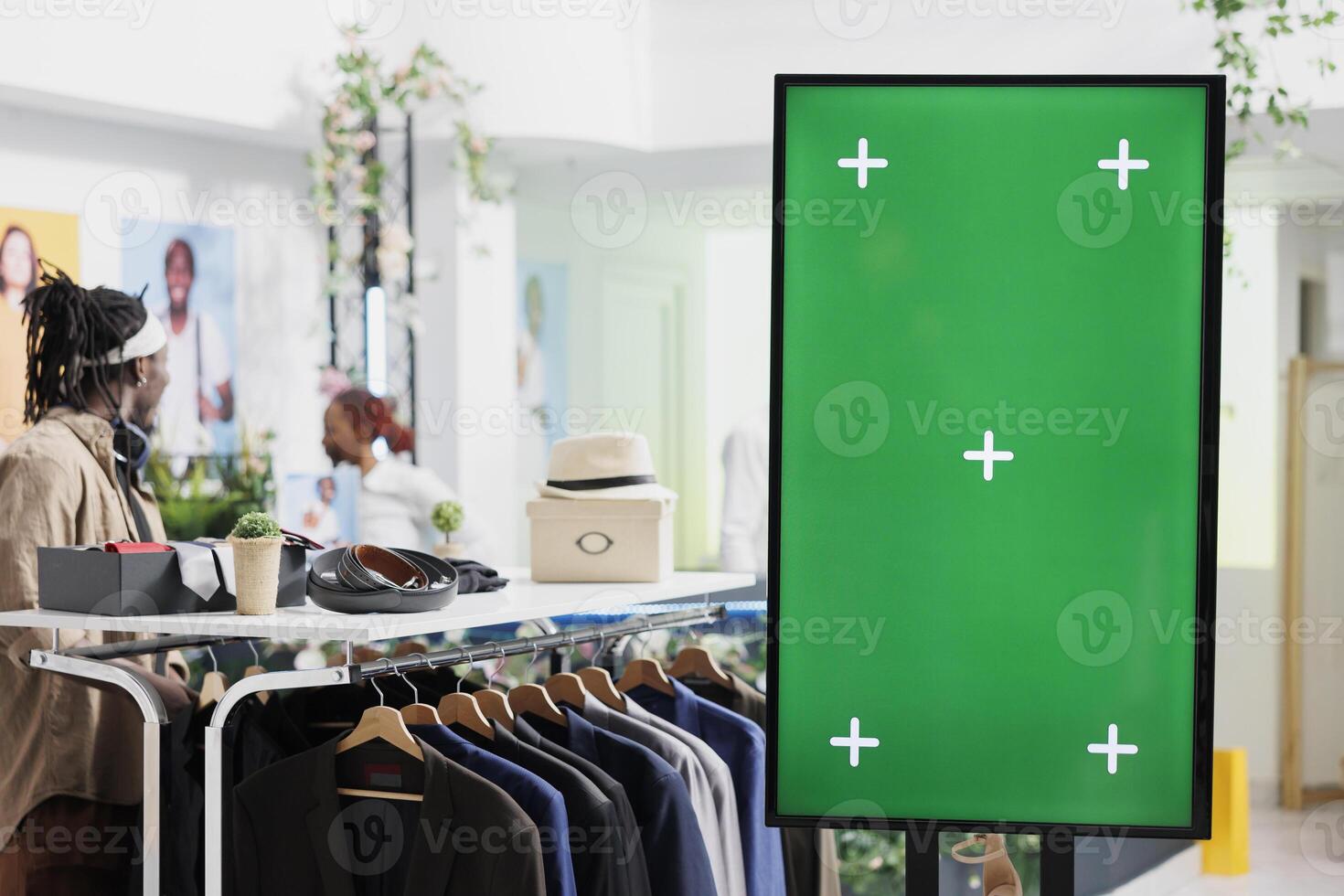 Digital board with green screen for clothes brand promotion mock up in shopping center. Smart display with chroma key for apparel new collection advertisement in fashion boutique photo