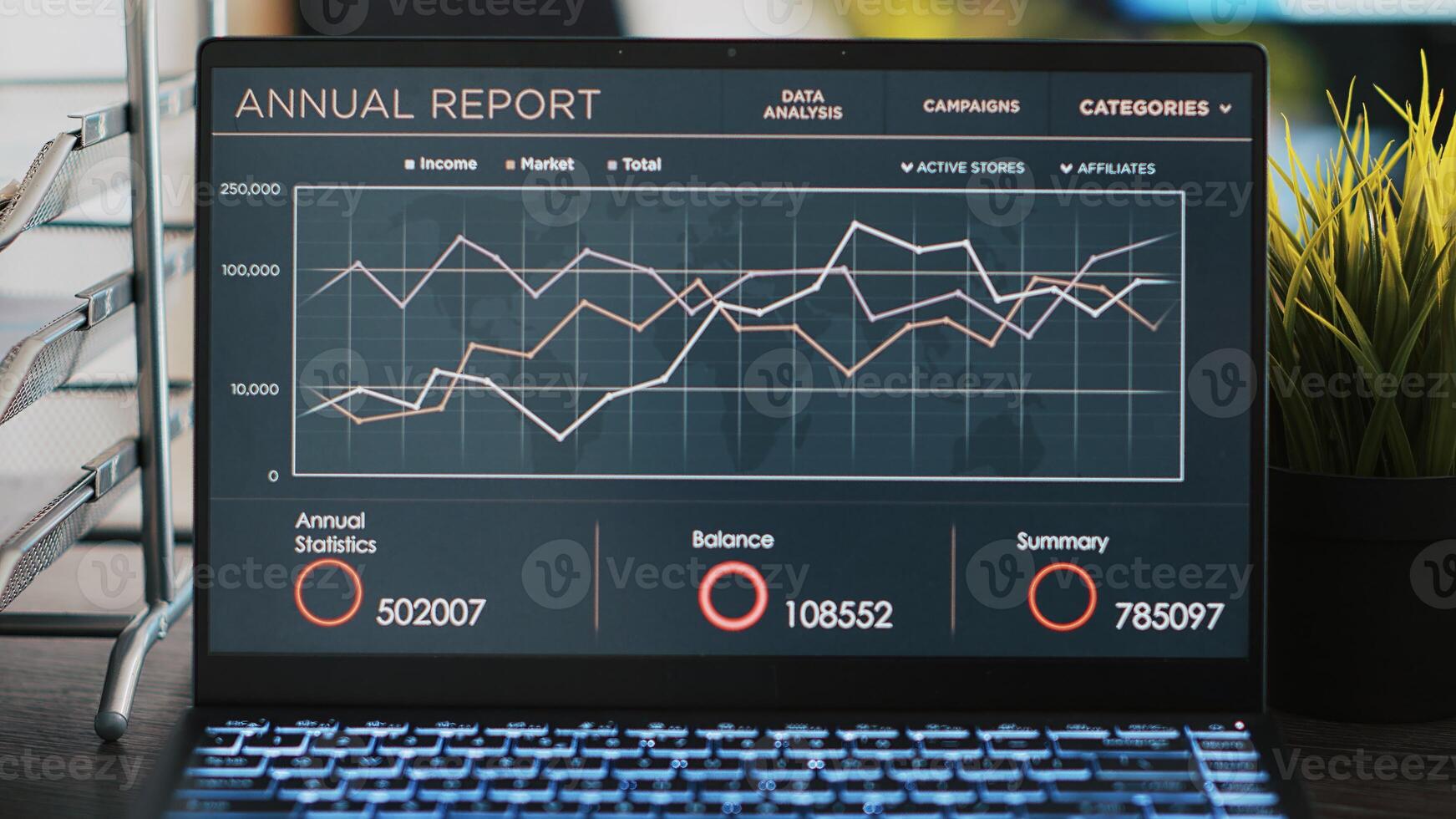 Business diagram and figures on laptop left open on desk in empty workplace, close up. Financial annual report charts on notebook screen in company accounting department office, panning shot photo
