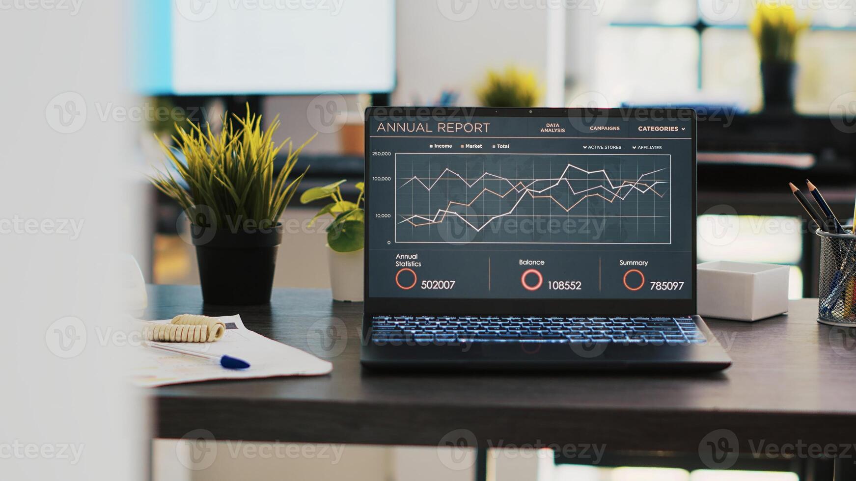 Business graphs and figures on laptop left open on desk in empty workspace. Economic annual report charts on notebook screen in company financial department office, panning shot photo