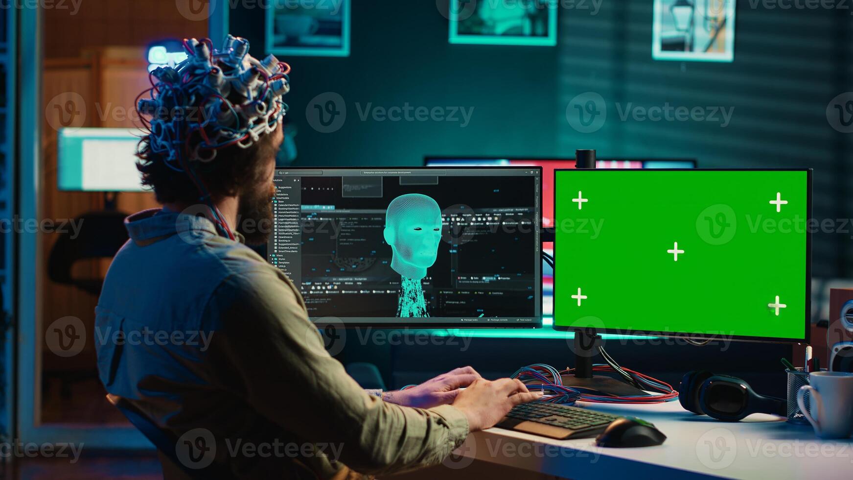 Developer using EEG headset, starting mind upload process using isolated screen desktop. Man using neuroscientific device to transfer consciousness into cyberspace with chroma key monitors, camera A photo