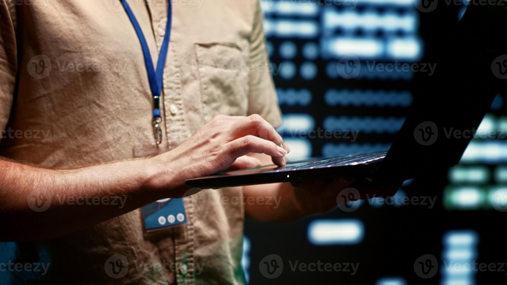 Close up of engineer in server hub using laptop to work with essential data for training machine learning models that power artificial intelligence systems necessitating storage, processing photo