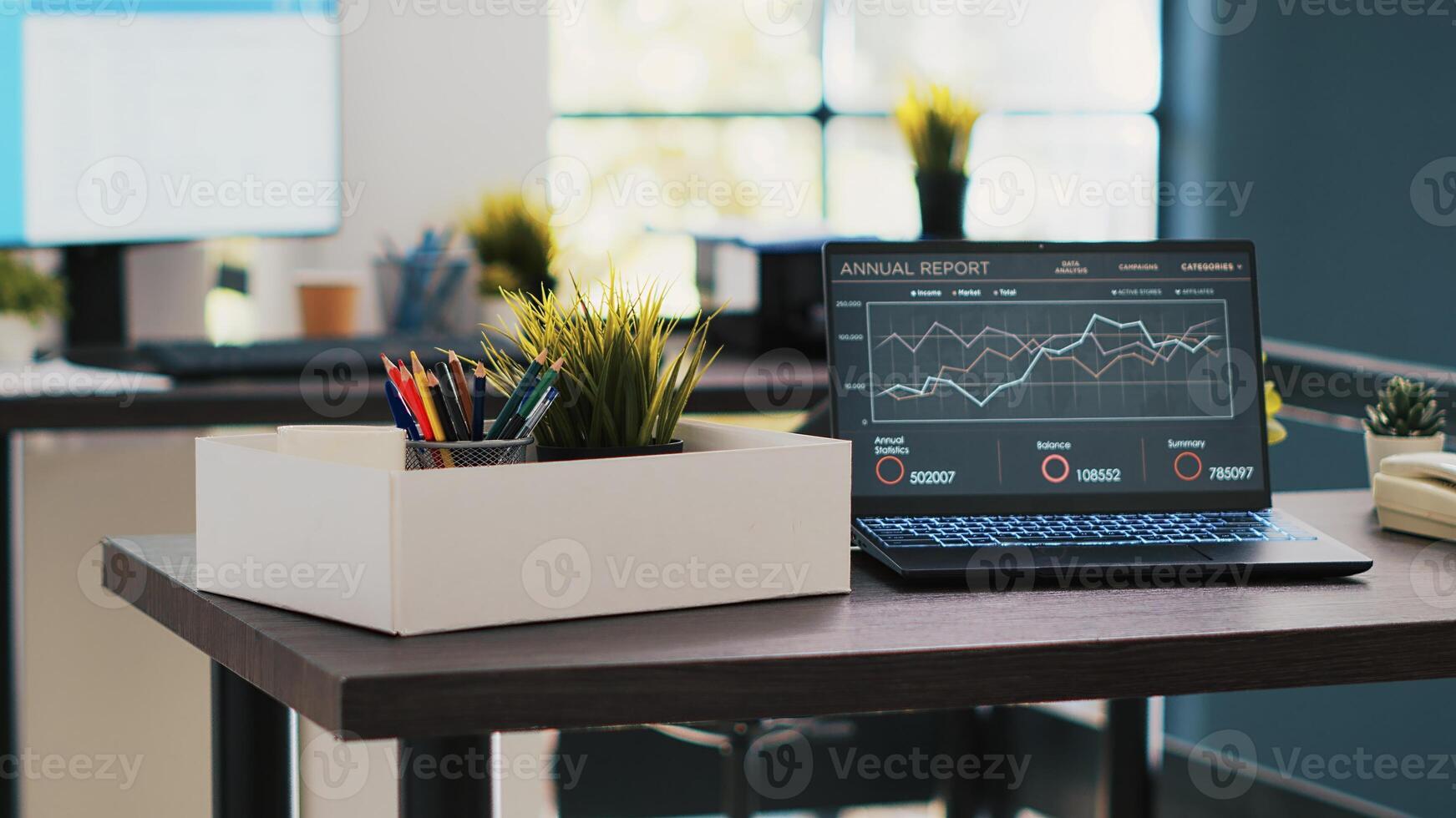 Business forecasting graphs showing profits on laptop in empty office. Economic annual revenue statistics report on notebook screen in accounting department office with no people in photo